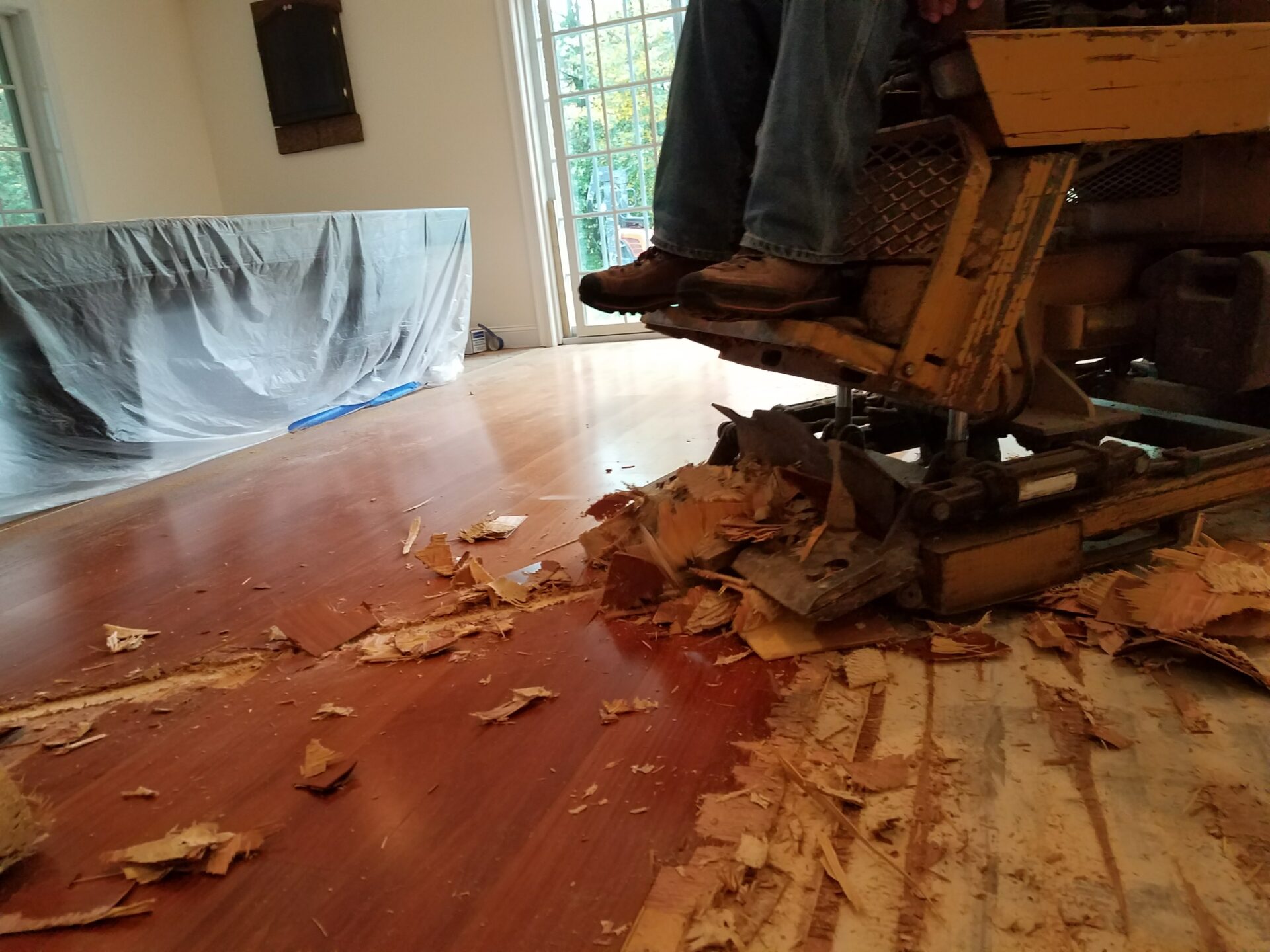Hardwoods in herringbone pattern glued down to slab. After the hardwoods were removed, an additional/extra pass was made to remove residual adhesive material.