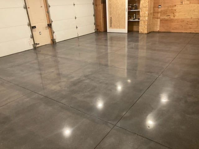 This garage in Weare, New Hampshire before and after photos.  With new concrete, it is important that the slab is properly finished.  Otherwise, it will result in additional time and charges. Also added guard and burnished.