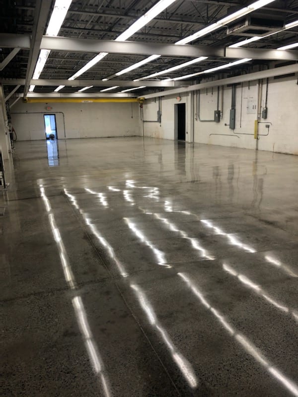 10,000 square foot industrial space. The floors of this Machine Shop had many layers of epoxy and paint. This is a common practice as epoxy and paint are applied over the previous layers. (Maybe we include, why a machine shop benefits from a polished floor. Why is it worth getting it done. This could be a few sentences or longer for a more detailed post that I can link back to) When we got down to the bare floor, we were able to give it a full warehouse polish and burnish. A 40,000 sq ft building (we did 10K) and grew over the years. The floors had a few levels of epoxy and paint which is typical since people just kept painting over the floor. We scrapped and ground down the paint and epoxy.